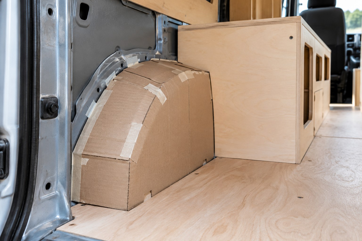 Cardboard template fitted around a van wheel arch